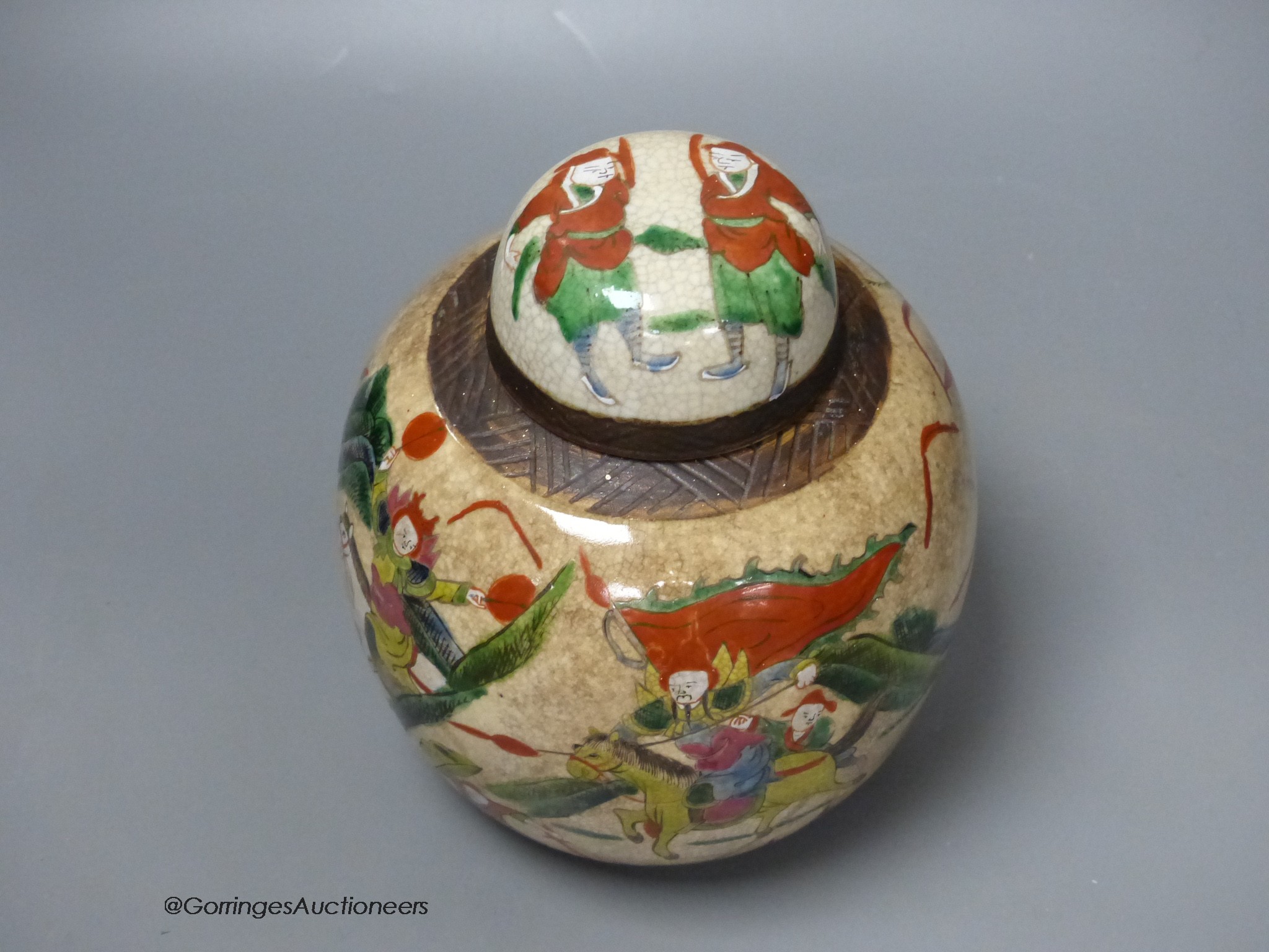 An early 20th century Chinese famille rose crackle glaze jar and cover, 20cm high